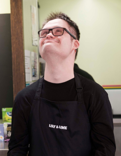 Young man with learning disabilities looking up with a happy smile